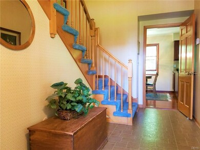 The two story foyer. Hardwood stairs under the car