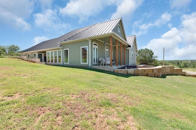 Back of house featuring a standing seam roof, a p