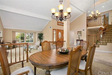 Formal dining area that is adjacent with a chandel