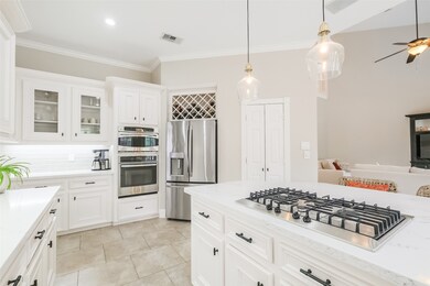 The kitchen also features stainless steel appliances, a built-in wine rack and a cabinet with glass doors to display your favorite glassware.