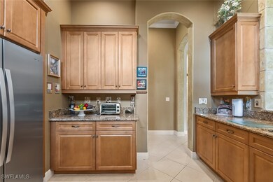 Kitchen featuring freestanding refrigerator, arche