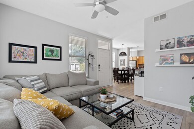 Living room featuring a ceiling fan and light woo