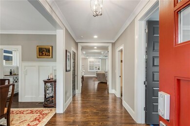 Entrance with crown molding, gleaming hardwood flo
