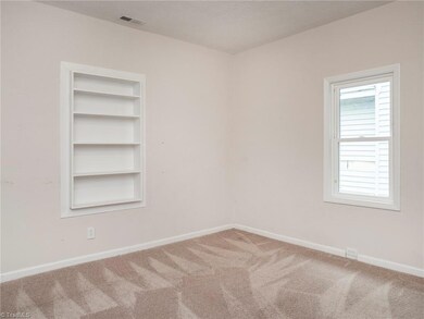 Bedroom 1 with built in shelves.