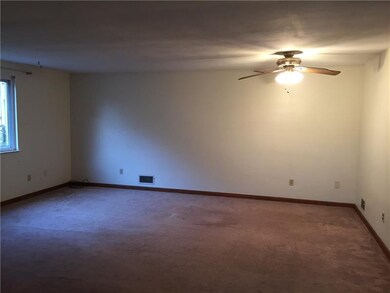The living room, dining room area has neutral dcor