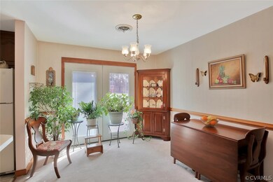 Formal dining room with French doors leading to 2-