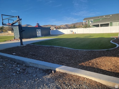 Fenced backyard featuring a mountain view