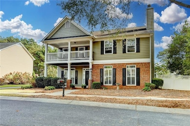 Craftsman house featuring covered porch, a chimney, a standing seam roof, and brick siding