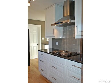 Love the modern exhaust and glass tile backsplash!