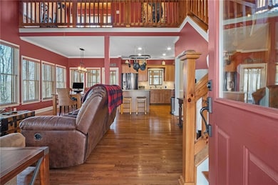 Living room with a chandelier, wood finished floor