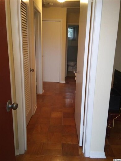 Hallway view upon entry, showing two closets and b
