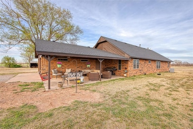 Rear view of property featuring a covered outdoor 