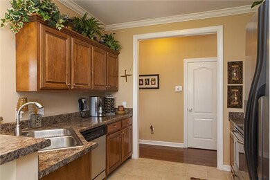 Your kitchen is open to the eat in area and features beautiful like new cabinetry, tiled flooring and stainless appliances.