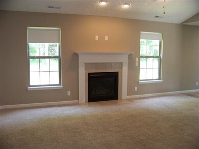 Note the Tile fireplace and vaulted ceilings.
