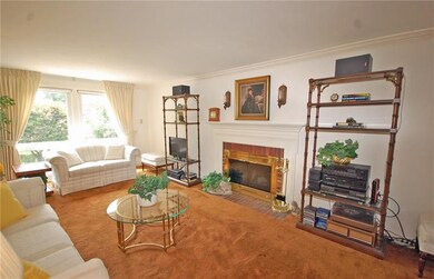 A spacious living room has hardwood floors under t
