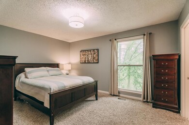 Spacious master bedroom with new carpet.