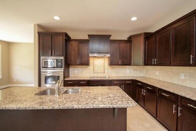 Custom kitchen with granite and custom travertine back splash. Hendersonville Tn 37075