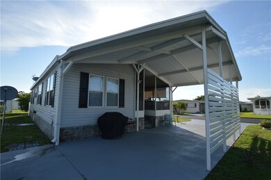 VIEW OF SCREENED PORCH THROUGH CARPORT