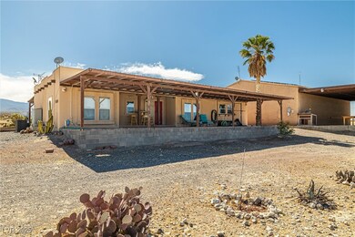Back of property with a patio area, central AC, an
