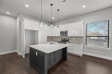 Kitchen featuring backsplash, stainless steel appliances, dark hardwood / wood-style floors, white cabinetry, and sink