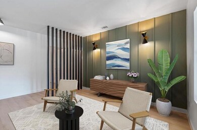 Living area with light wood-type flooring and bas