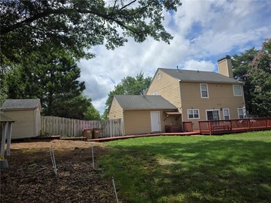 Rear view of property featuring a deck and a chimney
