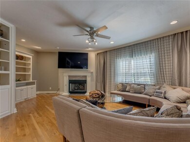 Main living room with bookshelves and fireplace.
