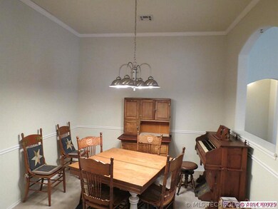 The formal dining room is spacious enough for a ch