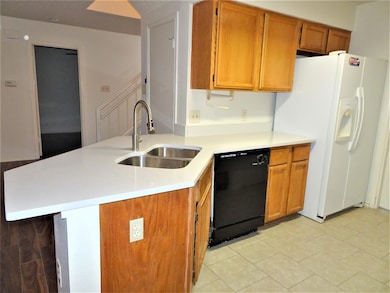 Kitchen featuring white refrigerator with ice dis