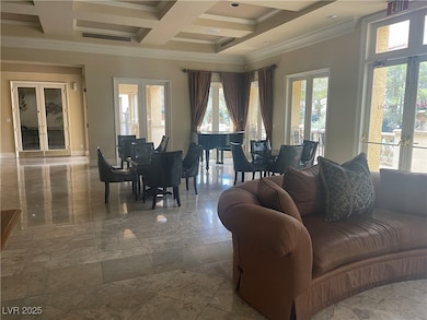 club house with ornamental molding, a chandelier, and french doors