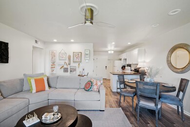 Living room featuring ceiling fan and hardwood / w