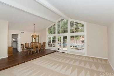 Formal Living and Dining Rooms feature soaring cei