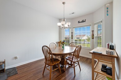 Dining room with dark hardwood / wood-style floori