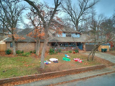 View of front of home with covered porch, a garage