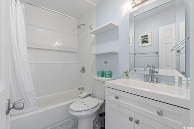 Full bathroom featuring shower / tub combo, toilet, and vanity