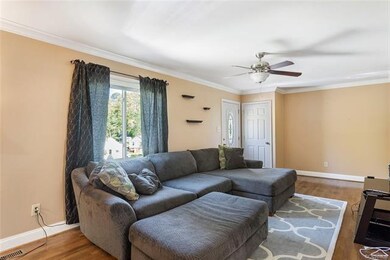 Large family room with hardwood floors, windows approximately 5 years old