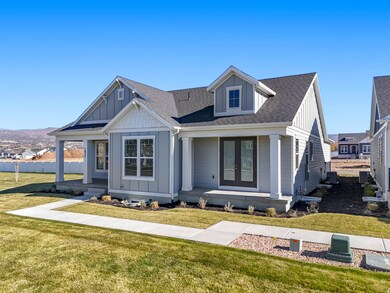 View of front facade with board and batten siding, roof with shingles, a porch, and a front lawn