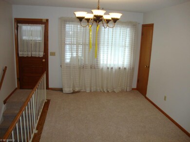 Carpeted dining area with great view of spacious b