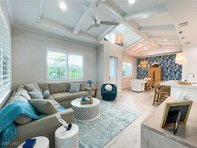 Living room with wood-type flooring, lofted ceilin
