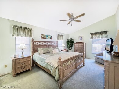 Carpeted bedroom featuring vaulted ceiling, multip