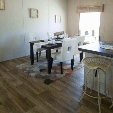 Dining area featuring dark wood-type flooring