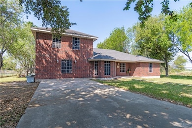 View of front of property featuring brick siding and concrete driveway
