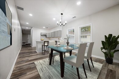 Dining room featuring recessed lighting, dark wood-style flooring, and a chandelier