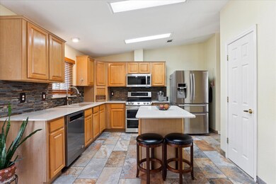 Kitchen featuring stone tile floors, decorative b