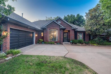 View of front of house with brick siding, concrete driveway, an attached garage, and a shingled roof