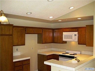 Open kitchen with vaulted ceiling & recessed light
