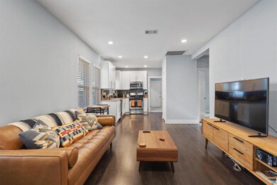 Living room featuring dark wood-type flooring, re