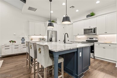 Kitchen with white cabinetry, decorative backsplas