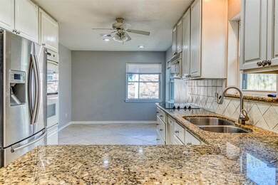 The kitchen is light and bright with everything the chef in your family desires - granite countertops, tile floors, double ovens, and double undermount sinks are just some of the bonus features it offers.