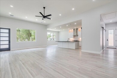 Unfurnished living room with attic access, recess